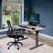 Electric Standing Desk with ComfortEdge in 48x30 Reclaimed Wood in lowered position at home